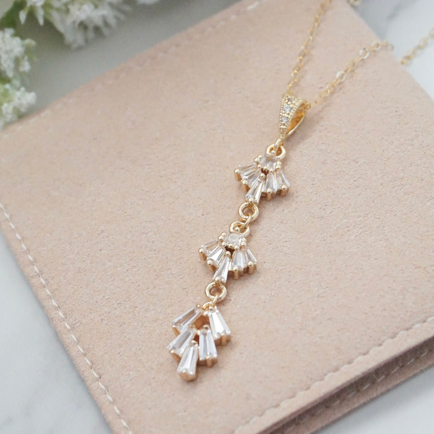 A geometric art deco style pendant laying flat on a surface