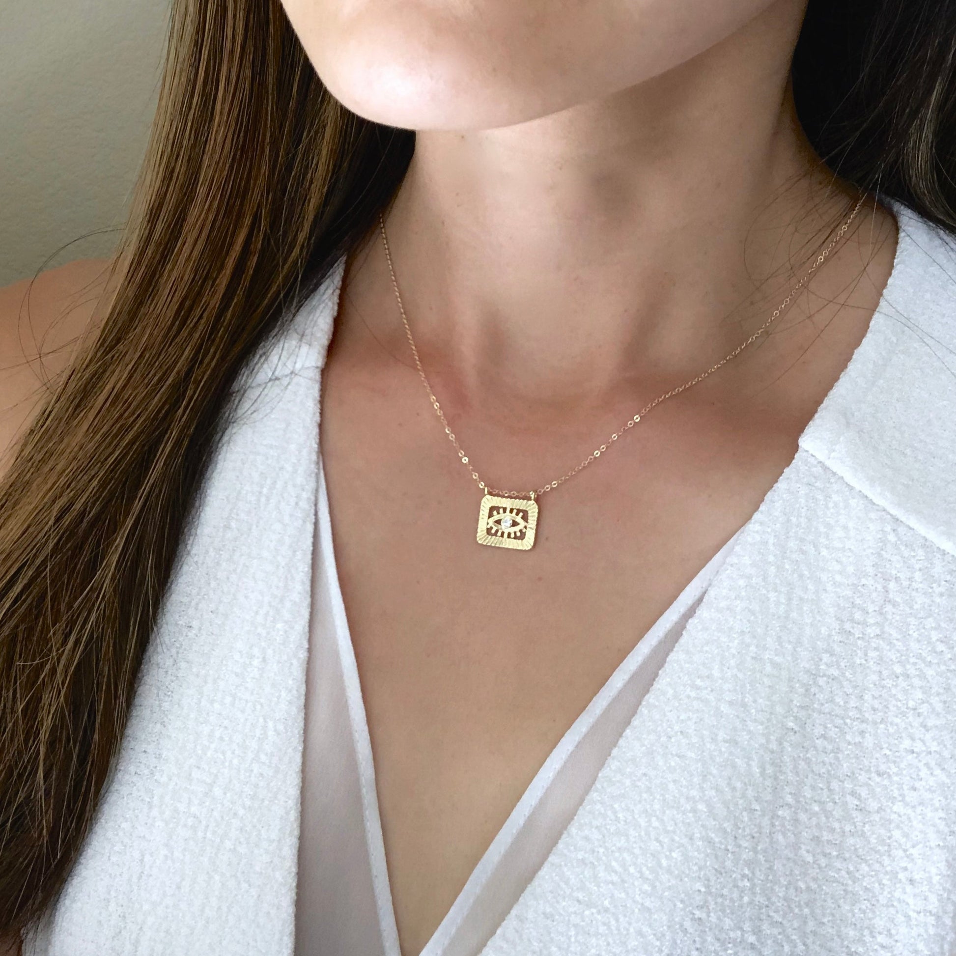 woman wearing evil eye necklace