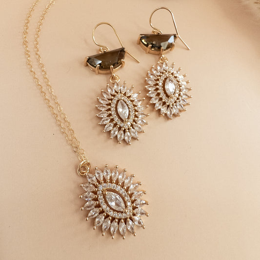 Gold starburst crystal earrings with smoky brown stones and matching starburst pendant necklace