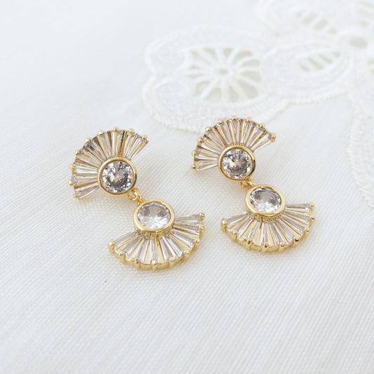 Art Deco earrings featuring fan shaped crystals on a white surface