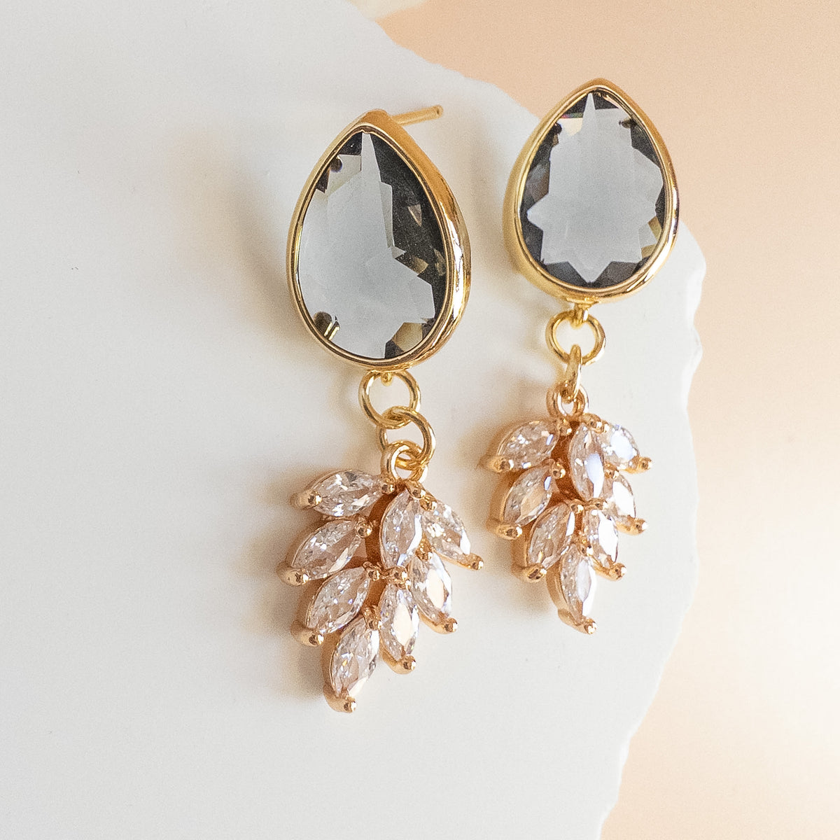 Gold earrings with charcoal grey teardrop crystal and marquise crystal cluster