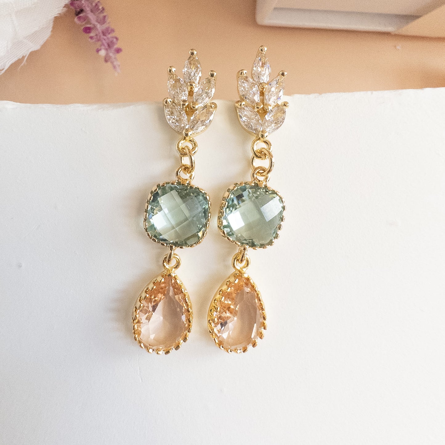 Pair of art deco marquise crystal drop earrings on a white background